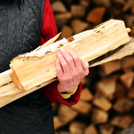Close Up of Person Holding Firewood